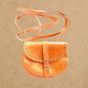 Small leather crossbody bag can also be looped through your belt. Made in Greece